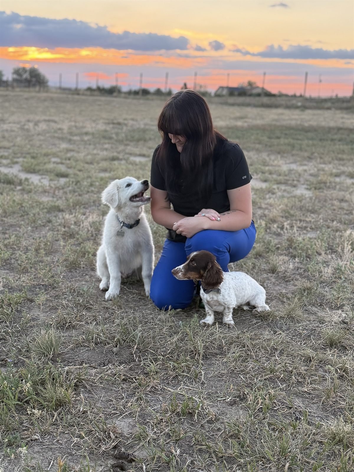 Natalie with her dogs at sunset
